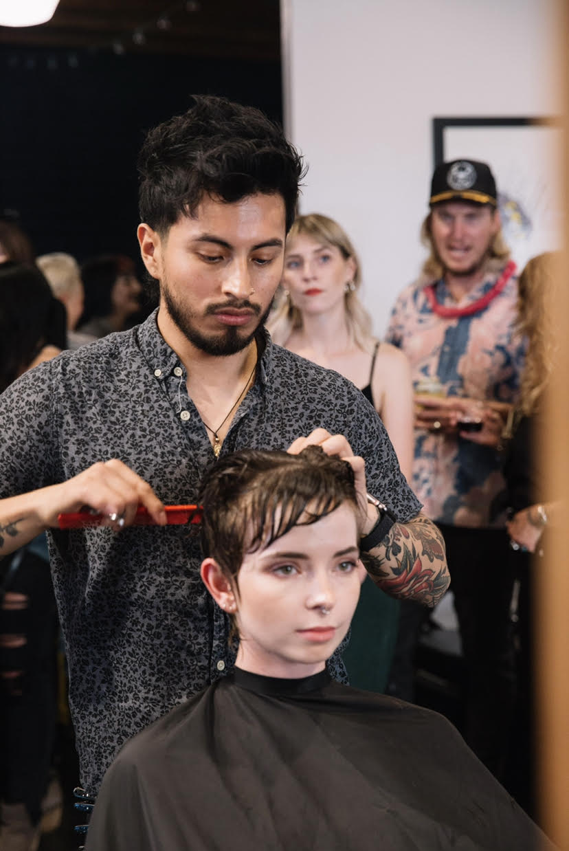Brian Aguilar dressing someone's hair