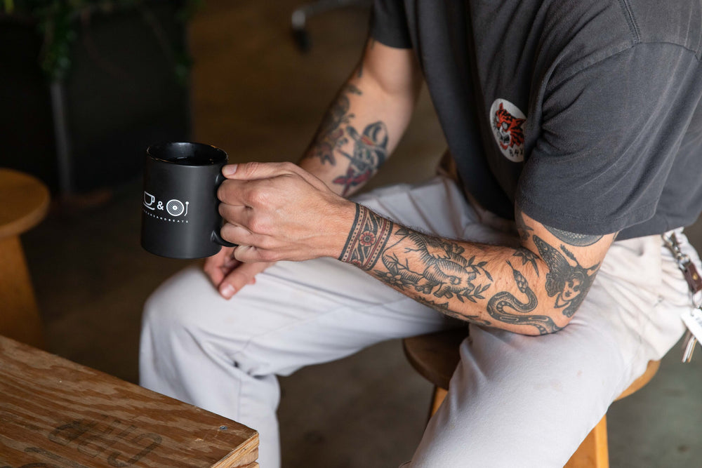 MAN HOLDING BEANSANDBEATS CERAMIC MUG