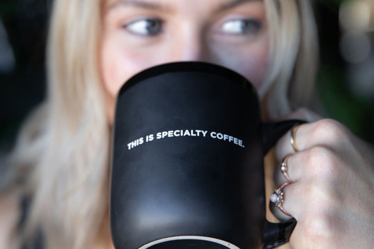 WOMAN DRINKING WITH THE SPECIALTY COFFEE MUG